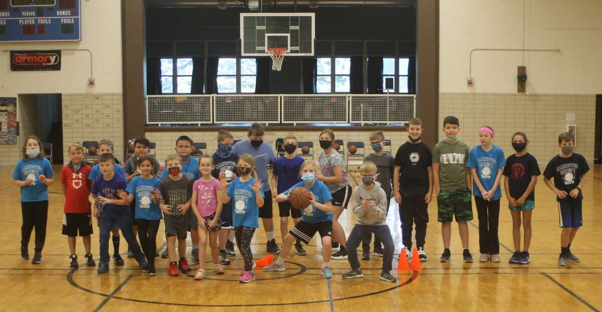 Attendees of the Jim Ogilvie Basketball Clinic pose for a photo at the Armory Youth Project during the program's last session on Saturday. The eight-week program was open to students in grades three through six.