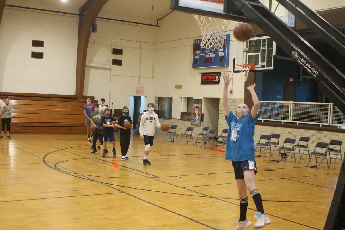 Students work on their left-handed layups at the Jim Ogilvie Basketball Clinic at the Armory Youth Project on Saturday.