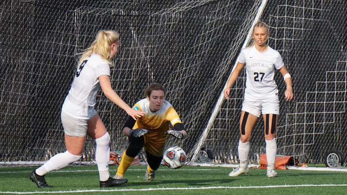 Saint Rose goalie Maurika Laurendeau dives on the ball as teammates Sanna Rein, left, and Ryleigh Hopeck offer assistance during their Division II NCAA Tournament game against Concord on Saturday, Dec. 4, 2021. Laurendeau had five saves Saturday.