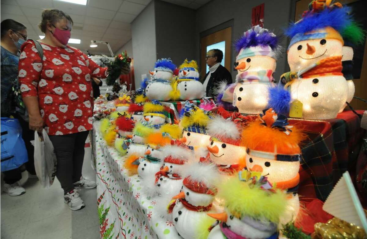 Kayla Mueller of Alton looks at snowman crafts during the Olde Alton Craft Fair. Hundreds turned out for the weekend event.