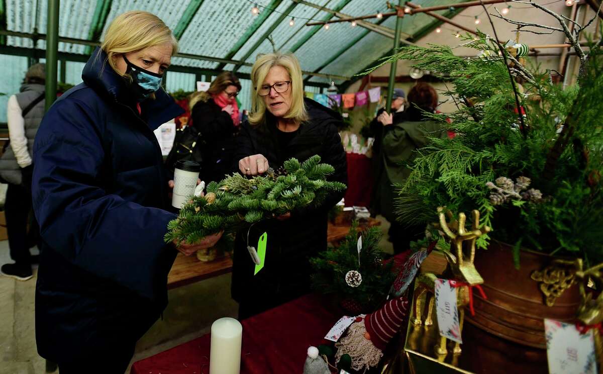 Gigi Schmidt and Andrea Kostanecki pick out items at the Rowayton Gardeners annual Christmas Market.