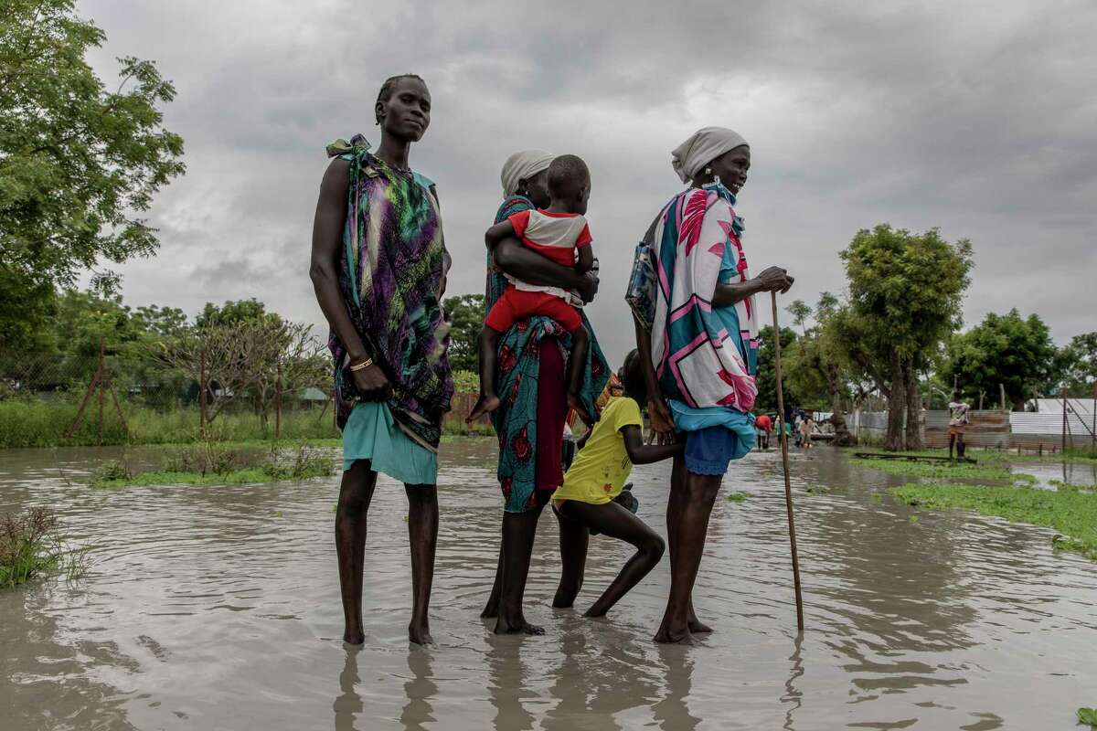 Martha Nyakoang and her family, after an hour's walk in waist-high water to get to church, in Old Fangak, South Sudan, on Oct. 3.