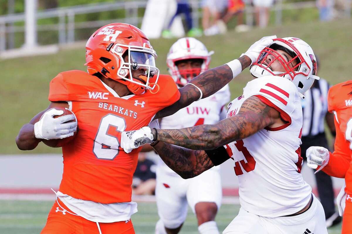 Sam Houston running back Noah Smith (6) pushes off Incarnate Word defensive back Moses Reynolds, right, during the first half of a football game Saturday, Dec. 4, 2021 in Huntsville, TX.