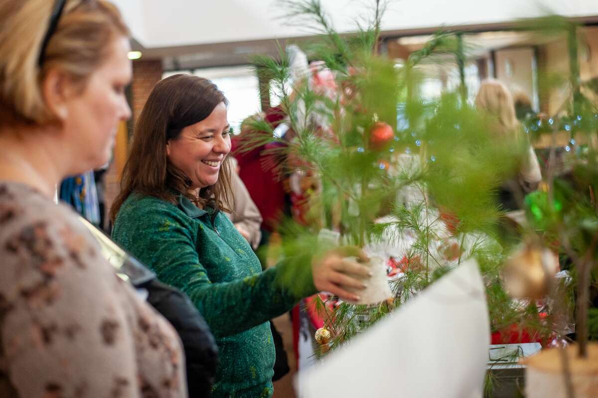 Midland resident Jennifer Decker buys a kindness tree at the Holiday Craft Bazaar on Dec. 4, 2021 at the Greater Midland Community Center.