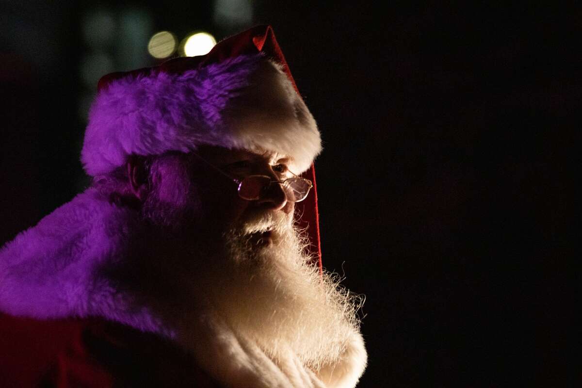 Santa Claus and Mrs. Claus wave to onlookers of the Christmas Parade of Lights Saturday, Dec. 4, 2021 in downtown Auburn.