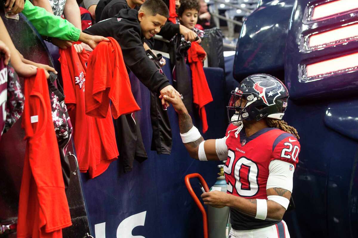 Houston Texans safety Justin Reid (20) safety greets a group of young fans before an NFL football game against the Indianapolis Colts Sunday, Dec. 5, 2021 in Houston.