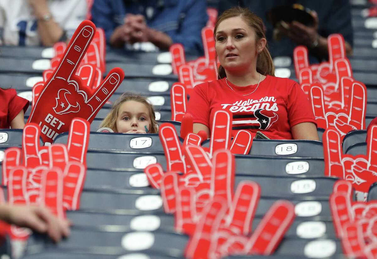 A little Houston Texans fan in her seats surrounded by foam hands during warmups before an NFL football game at NRG Stadium, Sunday, Dec. 5, 2021 in Houston.