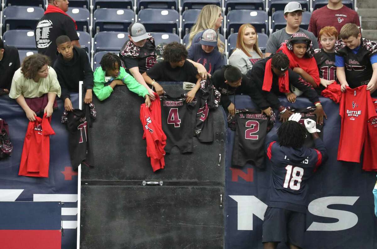 Houston Texans wide receiver Chris Conley (18) signs autographs for fans during warmups before an NFL football game at NRG Stadium, Sunday, Dec. 5, 2021 in Houston.