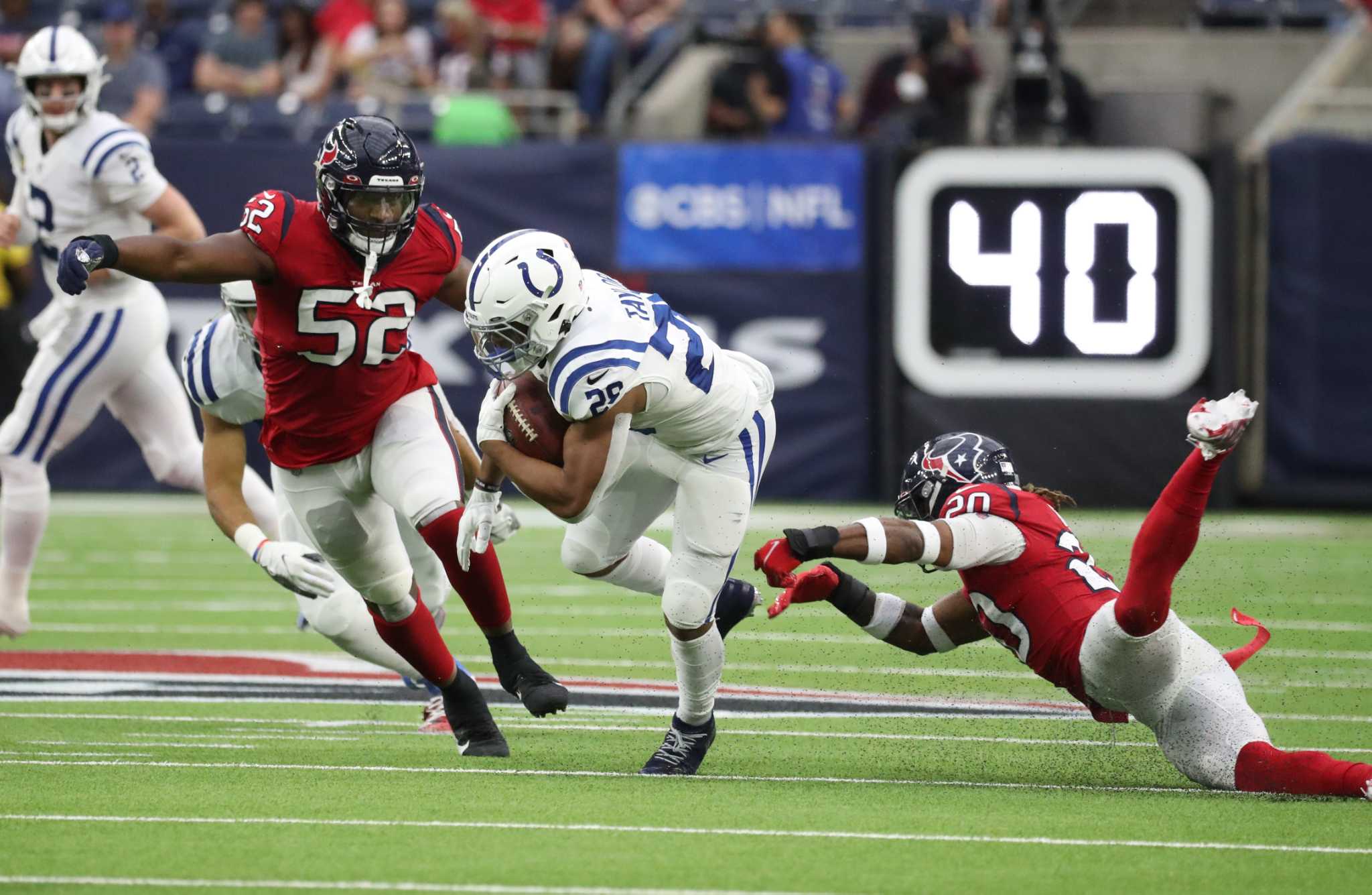 Houston Texans linebacker Christian Kirksey (58), Houston Texans defensive  back Tavierre Thomas (37) and Houston Texans defensive back Justin Reid  (20) bring down Indianapolis Colts wide receiver Ashton Dulin (16) during an