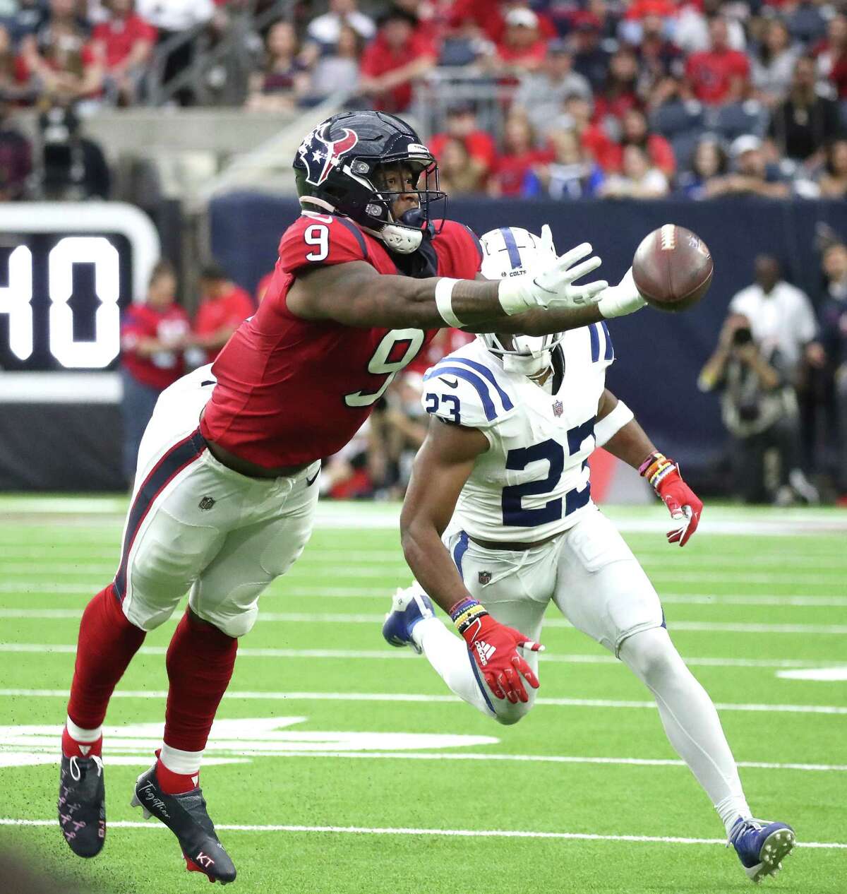 Houston Texans tight end Brevin Jordan (9) reaches out for a pass intended for him against Indianapolis Colts cornerback Kenny Moore II (23) during the first half of an NFL football game at NRG Stadium, Sunday, Dec. 5, 2021 in Houston.