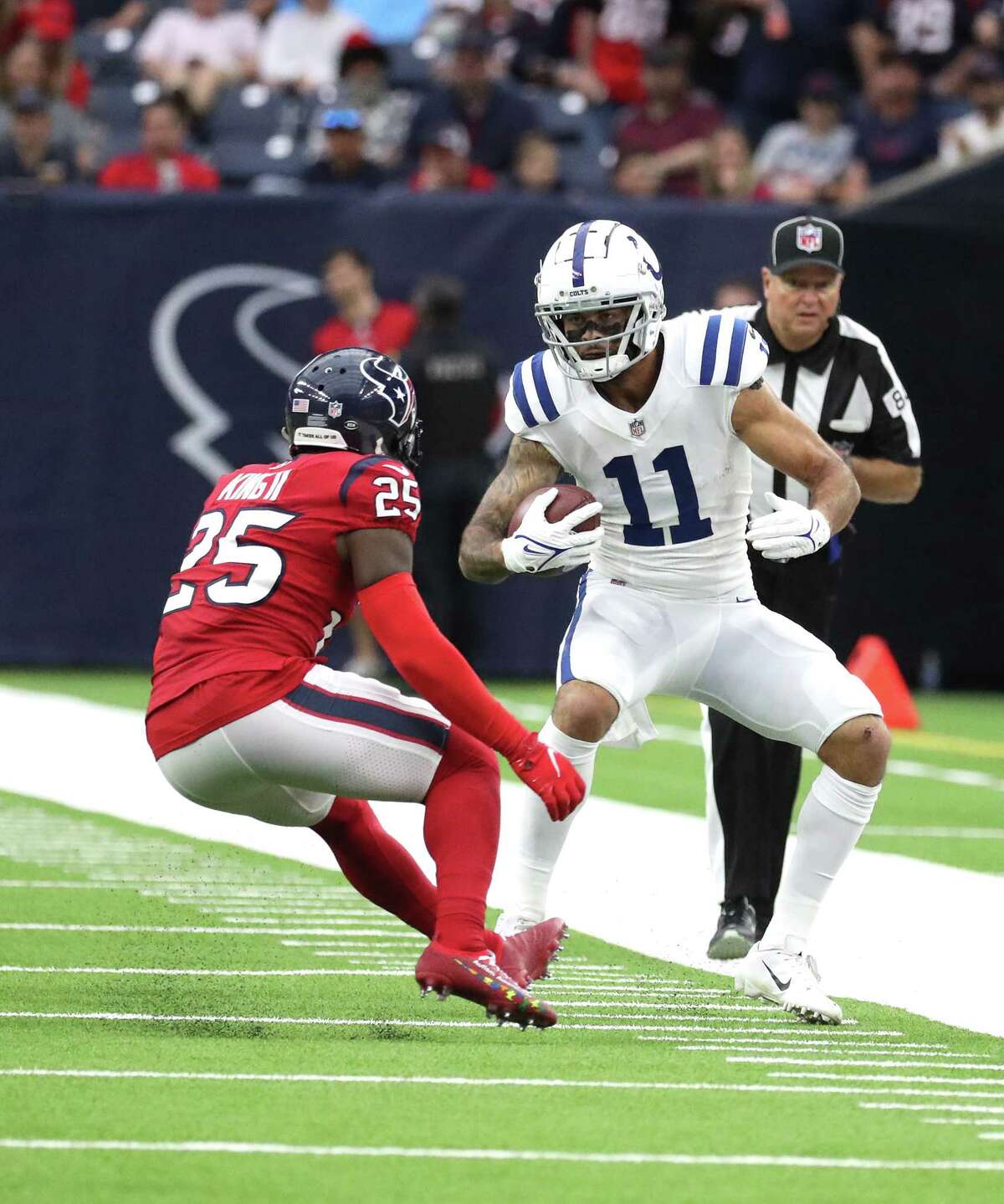 Indianapolis Colts wide receiver Michael Pittman (11) gains yardage against Houston Texans cornerback Desmond King II (25) during the first half of an NFL football game at NRG Stadium, Sunday, Dec. 5, 2021 in Houston.