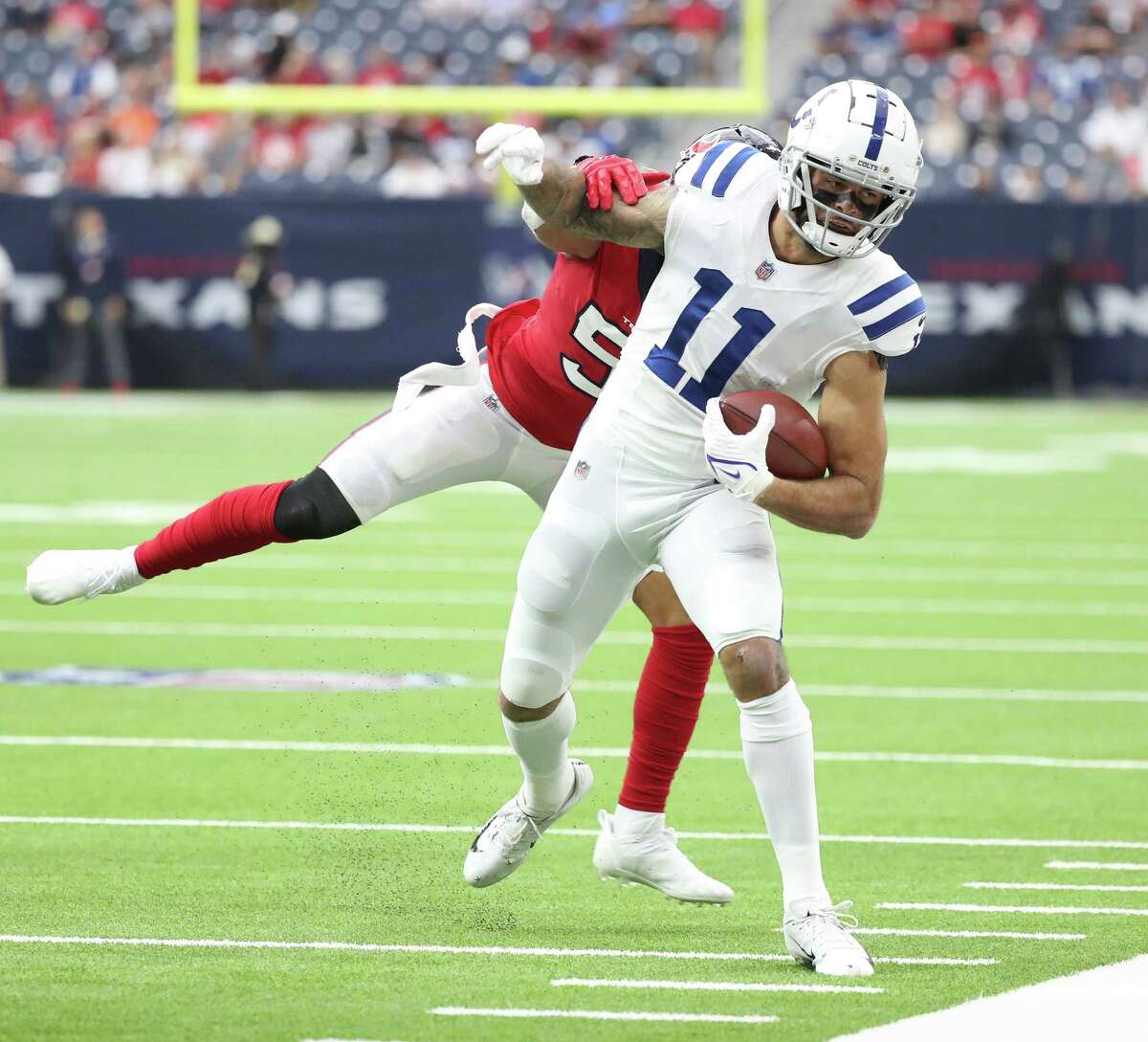 Indianapolis Colts wide receiver Michael Pittman (11) is tackled by Houston Texans outside linebacker Kamu Grugier-Hill (51) during the first half of an NFL football game at NRG Stadium, Sunday, Dec. 5, 2021 in Houston.