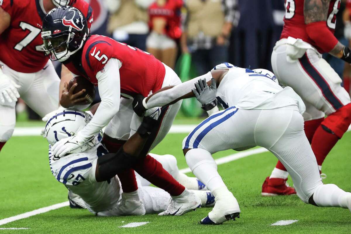 Houston Texans quarterback Tyrod Taylor (5) is sacked by Indianapolis Colts defensive end Al-Quadin Muhammad (97) during the second quarter of an NFL football game Sunday, Dec. 5, 2021 in Houston.