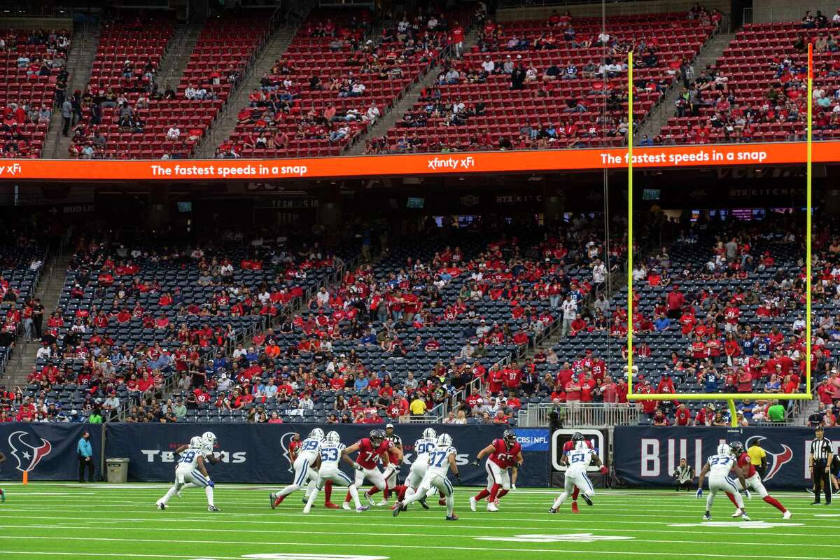 The Houston Texans run a play against the Indianapolis Colts in front of a sparse crowd during then first half of an NFL football game Sunday, Dec. 5, 2021 in Houston.