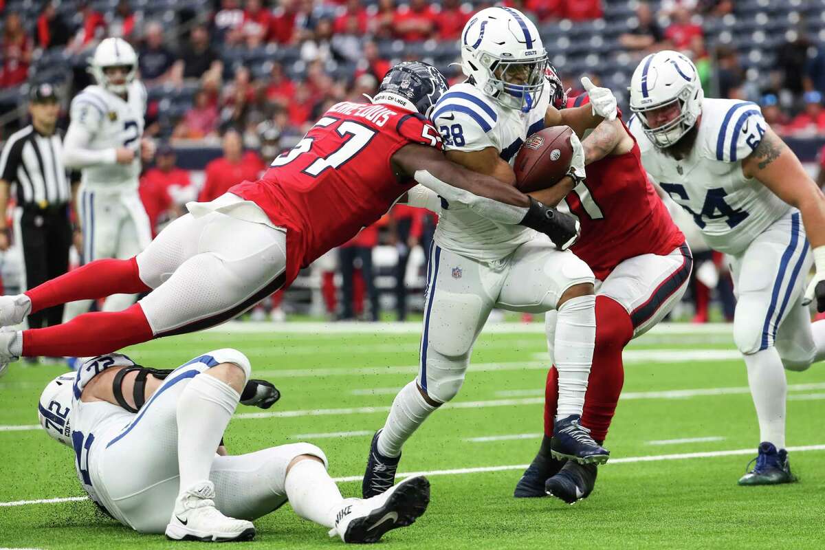 Indianapolis Colts running back Jonathan Taylor (28) is stopped short of the goal line by Houston Texans linebacker Kevin Pierre-Louis (57) during the first half of an NFL football game Sunday, Dec. 5, 2021 in Houston.