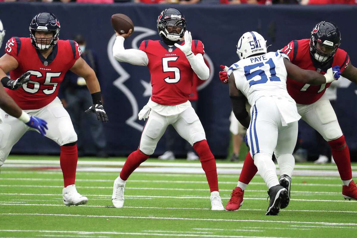 Houston Texans quarterback Tyrod Taylor (5) throws a pass over Indianapolis Colts defensive end Kwity Paye (51) during the first half of an NFL football game Sunday, Dec. 5, 2021 in Houston.