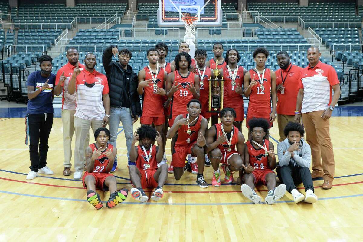 The Westfield Mustangs pose after defeated the Seven Lakes Spartans to win the Gold Bracket championship of the Katy ISD Basketball Classic on Saturday, December 5, 2021 at the Leonard Merrill Center, Katy, TX.