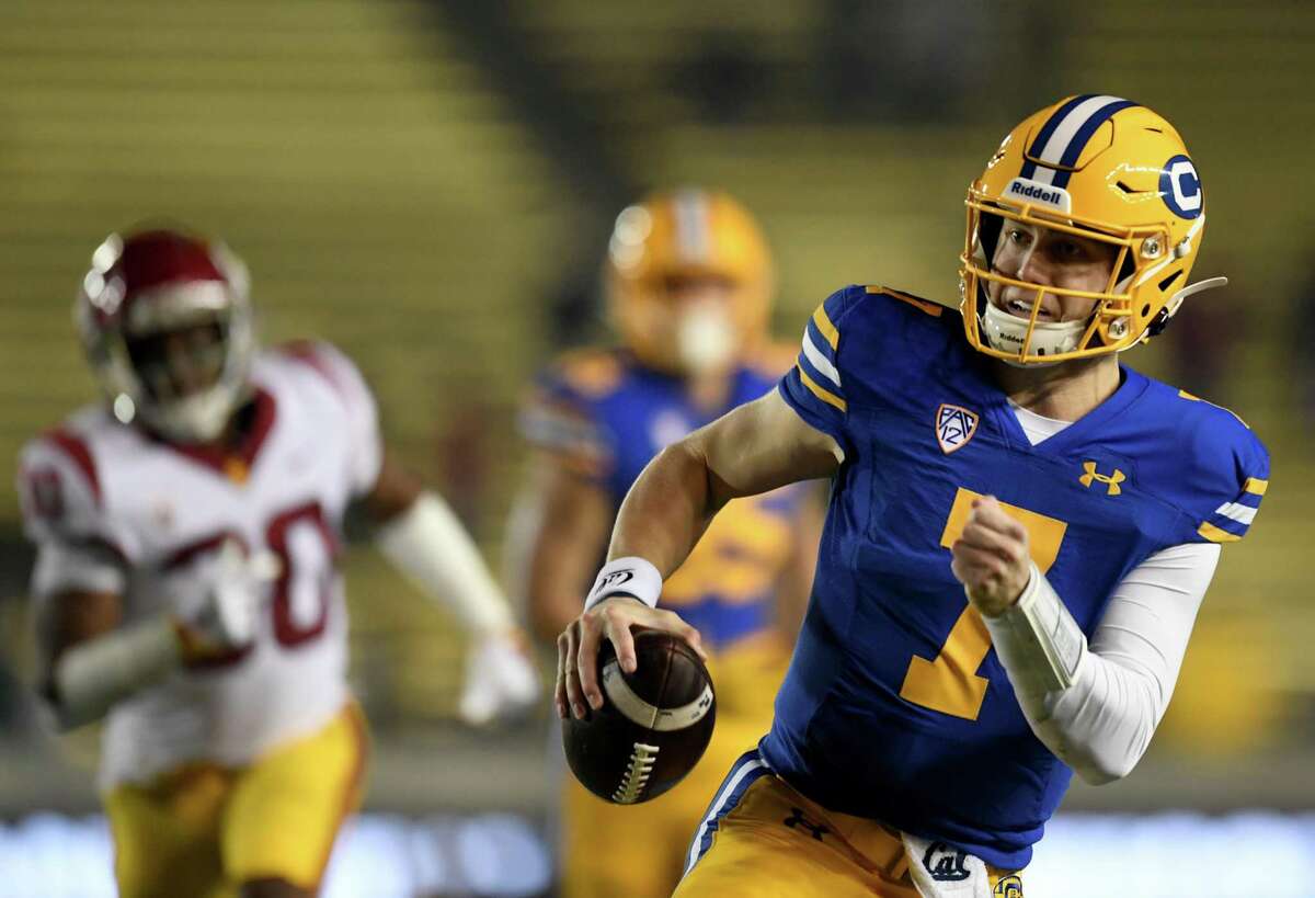 BERKELEY, CALIFORNIA - DECEMBER 04: Quarterback Chase Garbers #7 of the California Golden Bears runs away from pressure as they take on the USC Trojans at California Memorial Stadium on December 04, 2021 in Berkeley, California. (Photo by Michael Urakami/Getty Images)