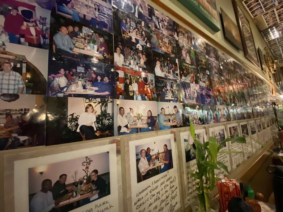 Thousands of photos of customers line the walls of the restaurant.