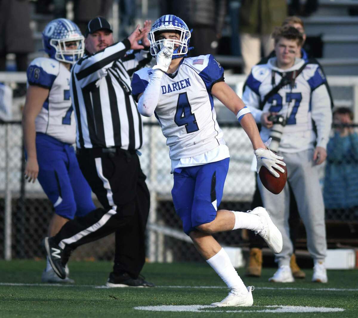 Darien defensive back Joe Cesare (4) celebrates after one of his three interceptions in No. 3 Darien's 24-10 win over No. 2 New Canaan in the CIAC Class LL high school football semifinal at New Canaan High School in New Canaan, Conn. Sunday, Dec. 5, 2021.