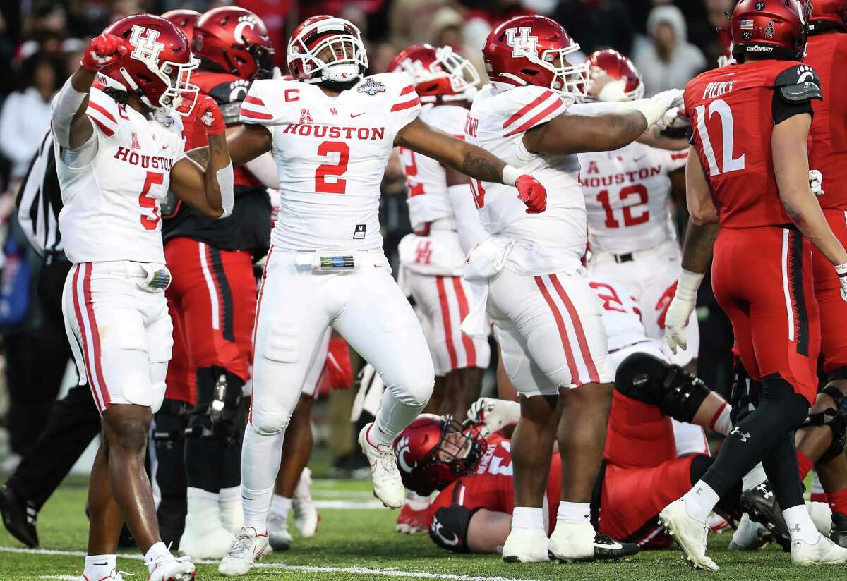Houston linebacker Deontay Anderson (2) celebrates after the Cougars defense stopped Cincinnati short of a first down short of the goal line to force a field goal try during the second quarter of the AAC Championship game Saturday, Dec. 4, 2021 in Cincinnati. The Bearcats missed the field goal attempt.