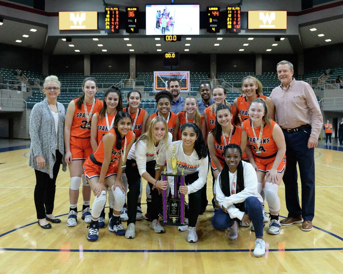 The Seven Lakes Spartans pose after their 44-36 victory over the Allen Eagles in the championship game of the Katy ISD Basketball Classic on Saturday, December 5, 2021 at the Leonard Merrill Center, Katy, TX.