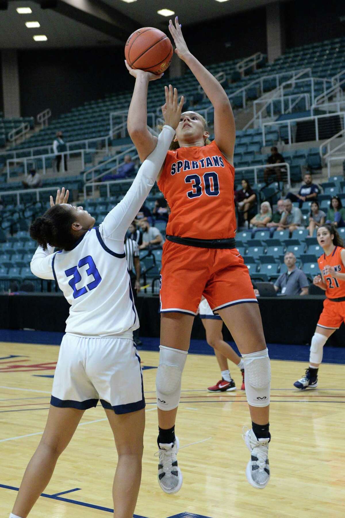 Justice Carlton (30) of Seven Lakes attempts a shot past Aryn Roberts (23) of Allen during the second half of the championship game between the Seven Lakes Spartans and the Allen Eagles in the Katy ISD Basketball Classic on Saturday, December 5, 2021 at the Leonard Merrill Center, Katy, TX.