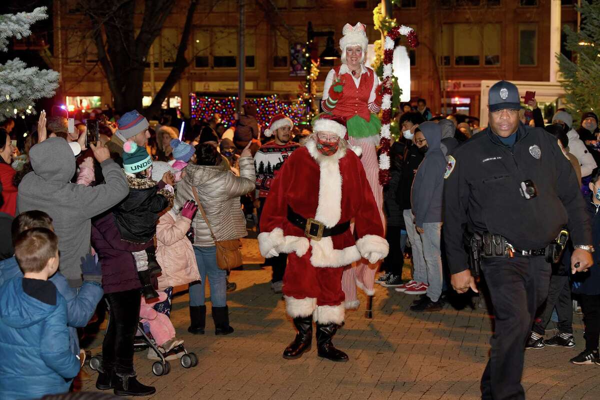 Santa Claus is escorted to his seat to meet with children and their families at the Danbury Library Plaza Saturday, Dec. 4, 2021 - all part of Danbury’s annual “Light the Lights” event, an annual tradition meant to celebrate the start of the holiday season.