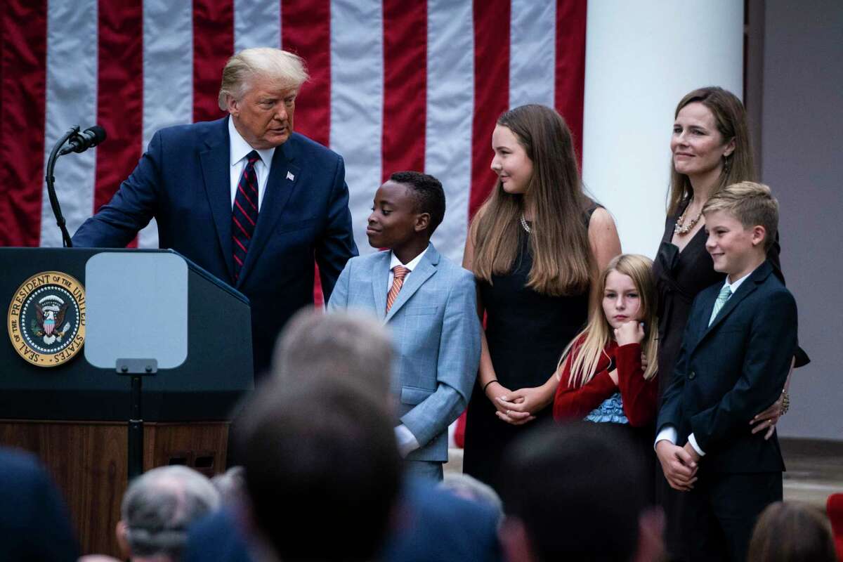 Trump poses with Judge Amy Coney Barrett and her family during a ceremony to announce Barrett as his nominee to the Supreme Court in the Rose Garden at the White House on Sept. 26, 2020.