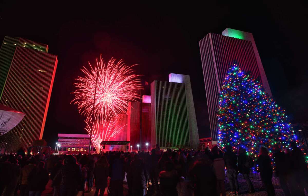 People gather at the Empire State Plaza to watch the fireworks after the New York State Holiday Tree was lit up on Sunday, Dec. 5, 2021, in Albany, N.Y.