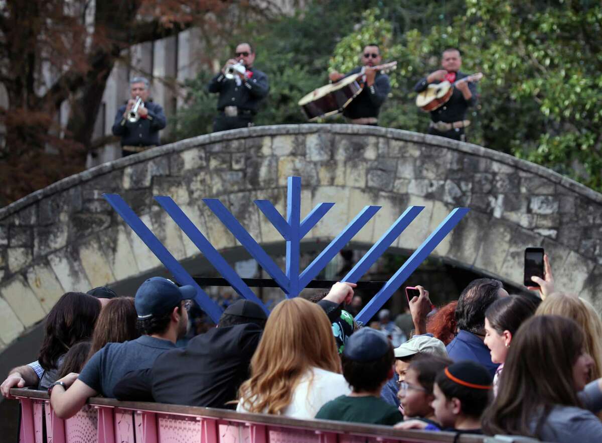 People enjoy a boat ride as a mariachi band performs during the Chabad Center for Jewish Life & Learning’s 24th annual Chanukah on the River at the Arneson River Theater on Sunday.