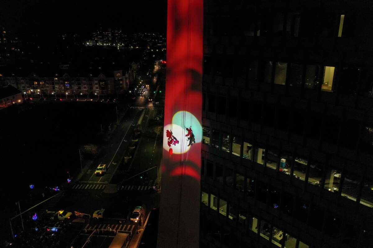 Santa and friends took a traditional leap off the tallest building in Stamford Sunday, rappelling down the Landmark Building.
