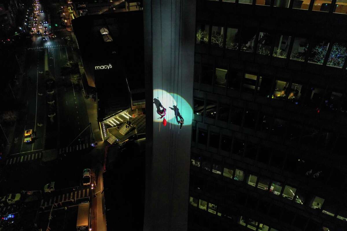 Santa and friends took a traditional leap off the tallest building in Stamford Sunday, rappelling down the Landmark Building.