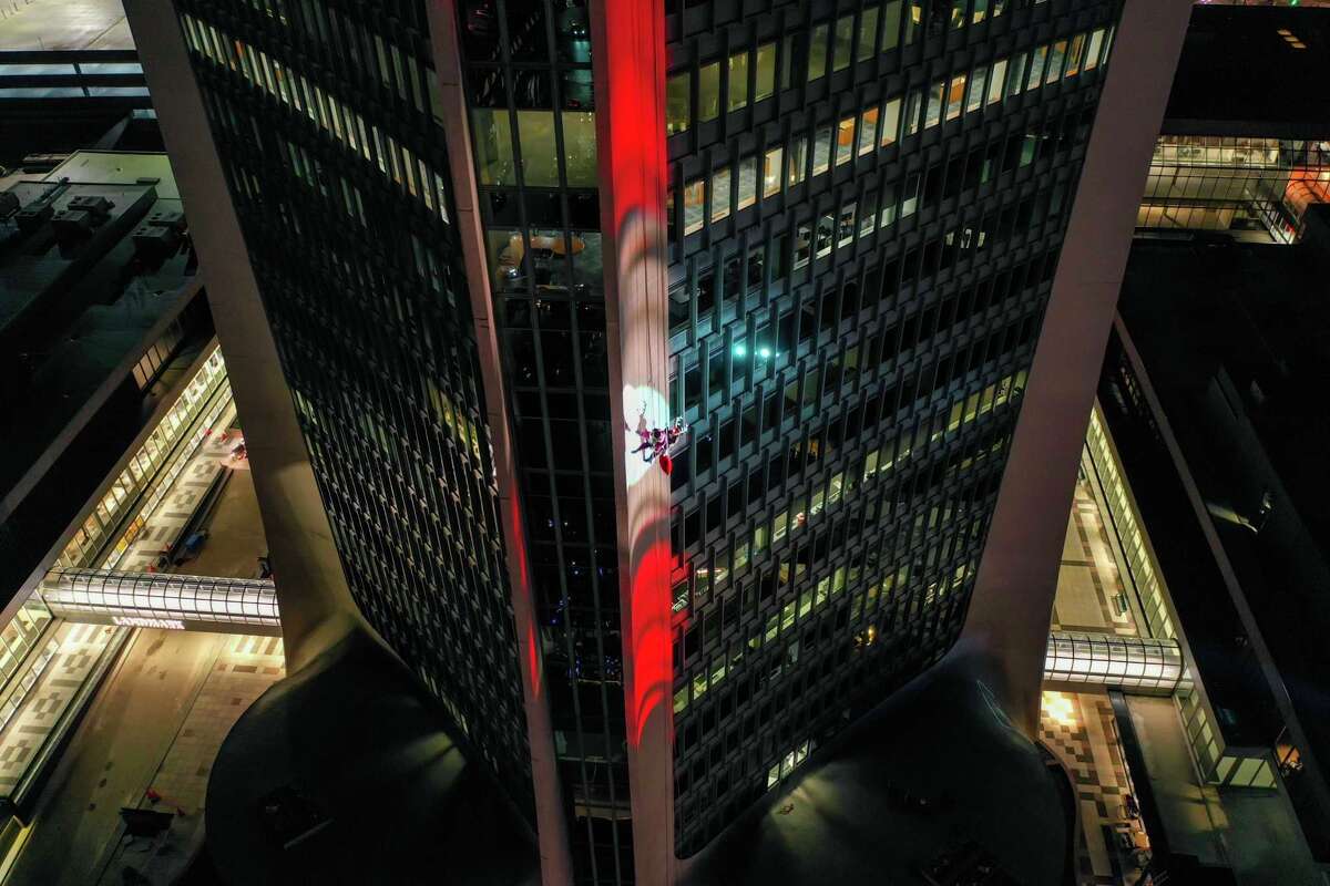 Santa and friends took a traditional leap off the tallest building in Stamford Sunday, rappelling down the Landmark Building.