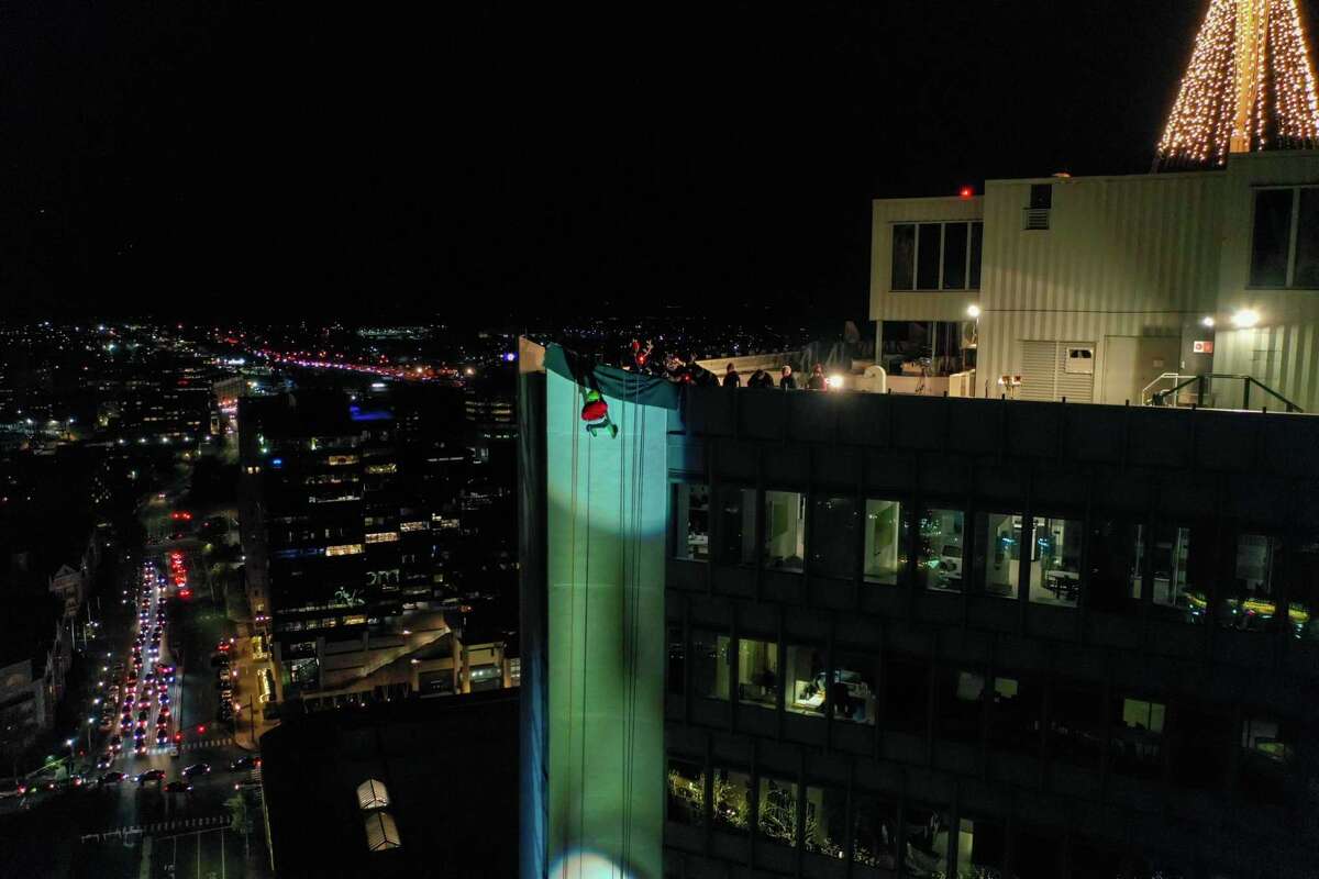 A drone view as Santa and friends took a traditional leap off the tallest building in Stamford Sunday, rappelling down the Landmark Building.