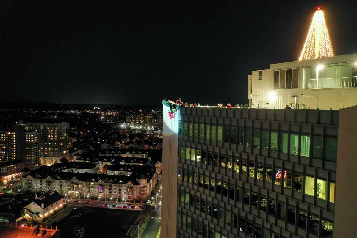A drone view as Santa and friends took a traditional leap off the tallest building in Stamford Sunday, rappelling down the Landmark Building.