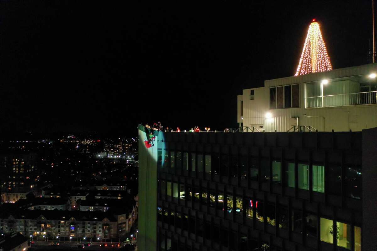 A drone view as Santa and friends took a traditional leap off the tallest building in Stamford Sunday, rappelling down the Landmark Building.