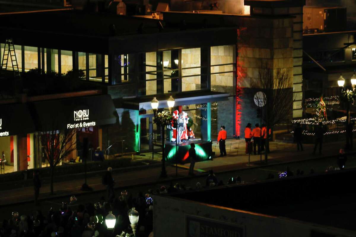 Santa and friends took a traditional leap off the tallest building in Stamford Sunday, rappelling down the Landmark Building.