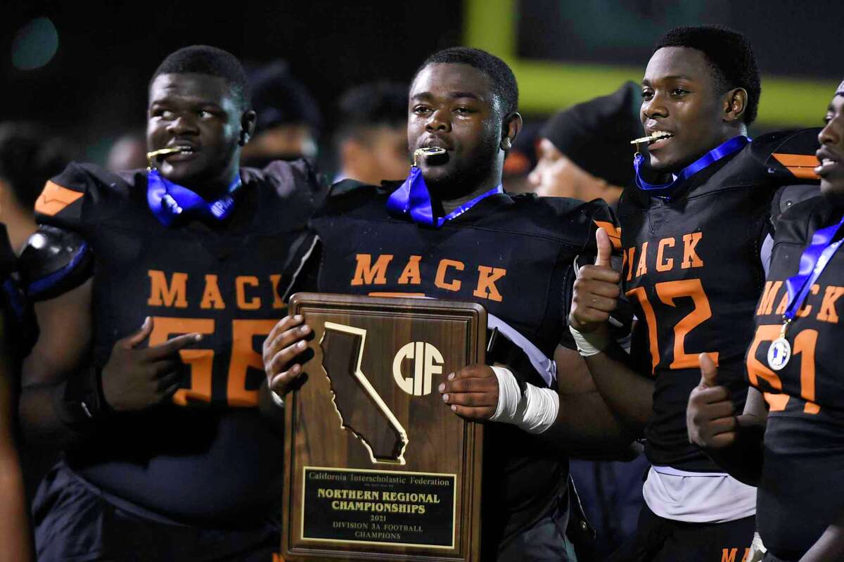 McClymonds players (left to right) Simeon Mitchell, Breece Hutchinson, Tigana Cisse and Malik Richardson celebrate the Warriors' fifth Northern California football championship, this one in Division 3-A after a 40-21 defeat of Campolindo.