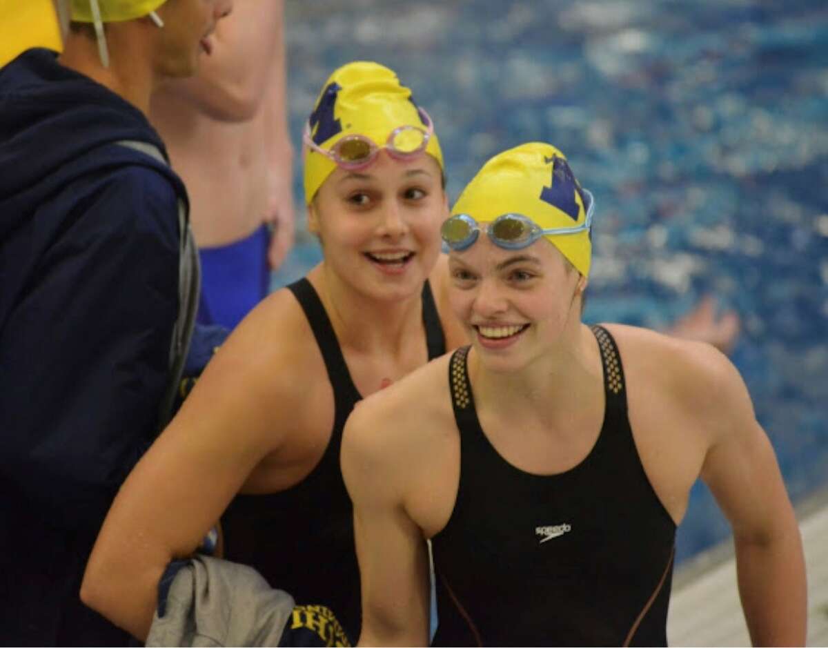 Michigan's Claire Newman (right) smiles after getting out of the pool at the Minnesota Invitational last weekend, Dec. 1-4, 2021.