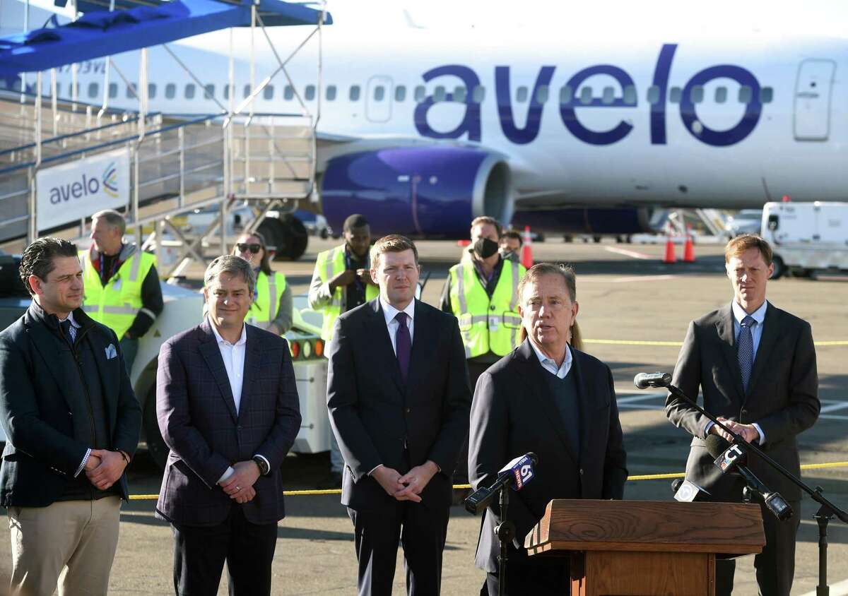 Gov. Ned Lamont, right, speaks during a ceremony before the Avelo Airlines inaugural flight from Tweed New Haven Regional Airport to Orlando on Nov. 3.