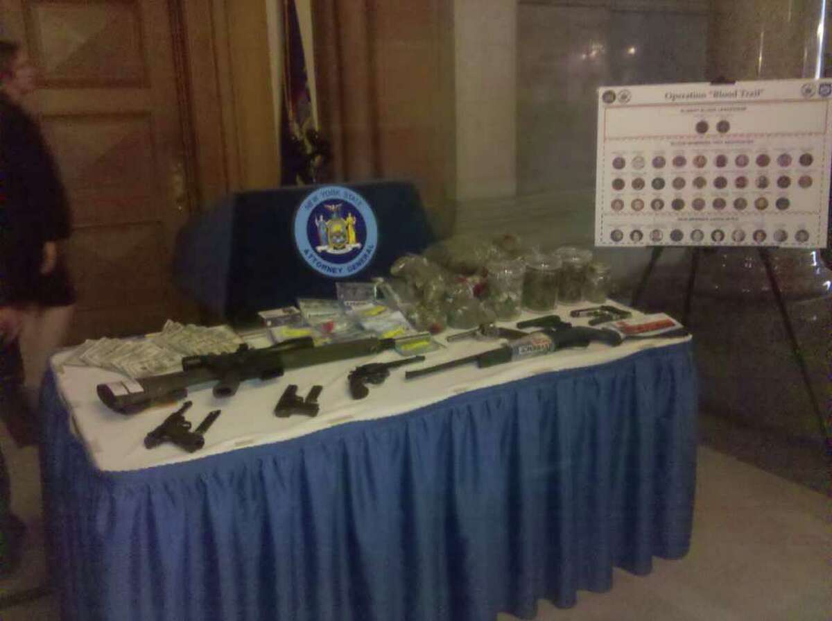 Weapons, marijuana and cash that state investigators said they seized during an investigation of the Bloods street gang in Albany (JORDAN CARLEO-EVANGELIST / TIMES UNION)