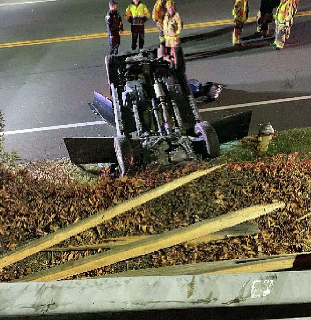 Fire officials said a vehicle drove through a barrier and fell about 12 feet in Shelton, Conn., on Sunday, Dec. 5, 2021.