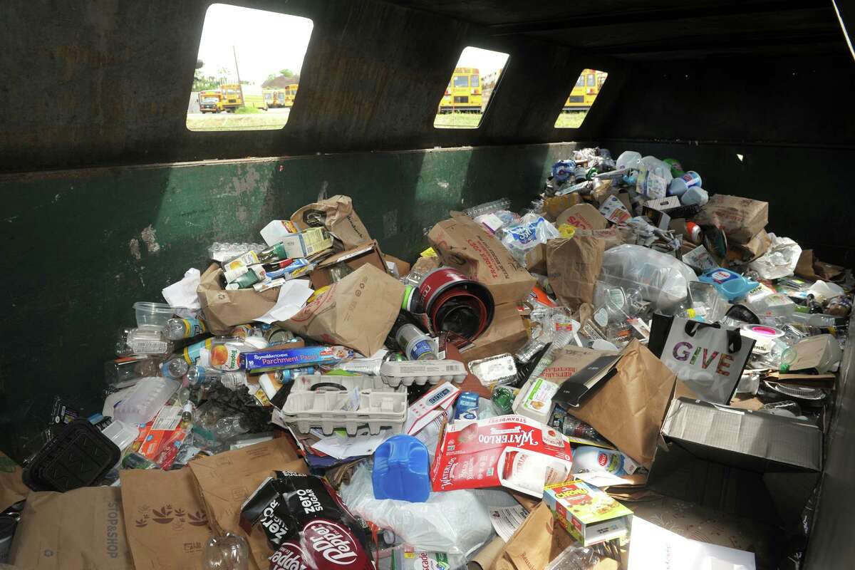 A look inside one of the dumpsters where residents can dump their recycling items at the town’s transfer station, in Fairfield, Conn., in June 2021.