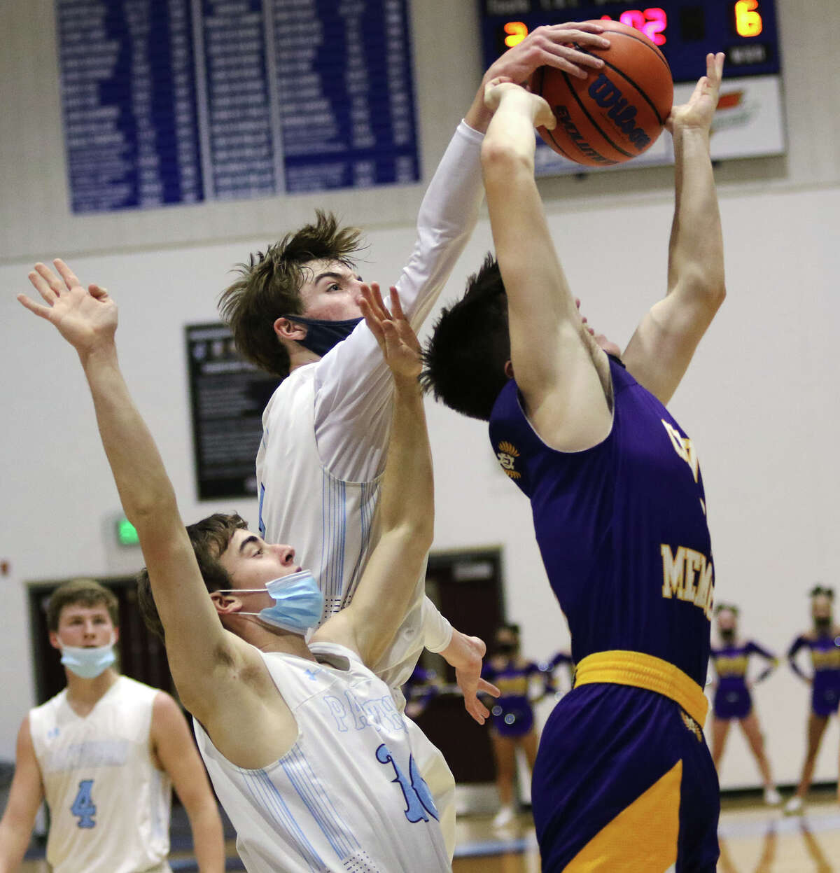 Jersey's Jaxon Brunaugh goes up to block a shot by CM's Manny Silva (right) while the Panthers' Trenton Decker (11) avoids contact in the first half of Friday's MVC boys basketball game at Havens Gym in Jerseyville.
