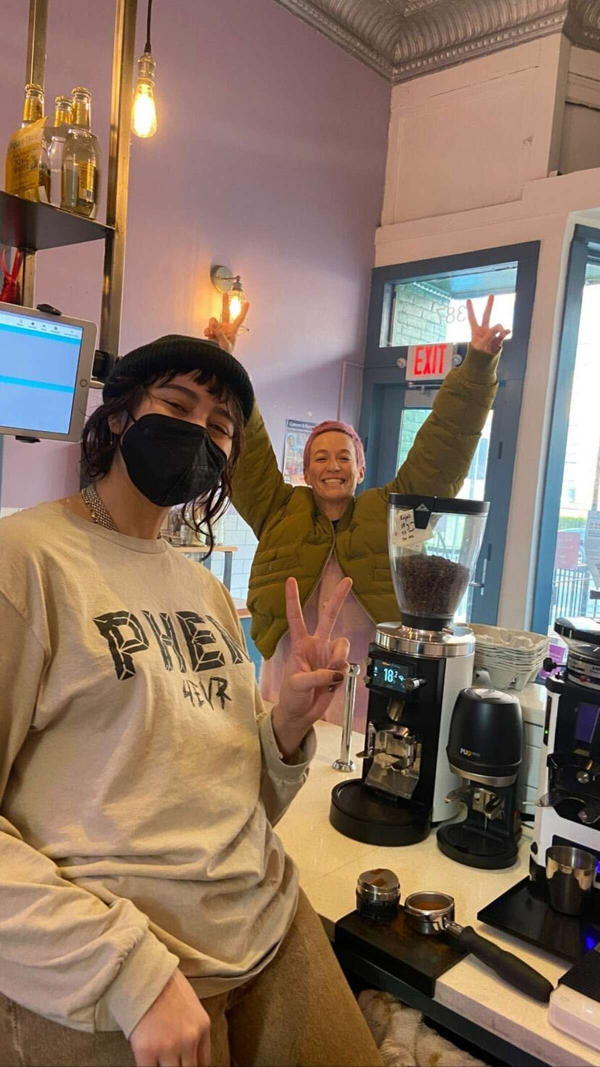 Soccer star Megan Rapinoe at Hartford's Story & Soil Coffee, posing for a photo with barista Sierra Kihega. 