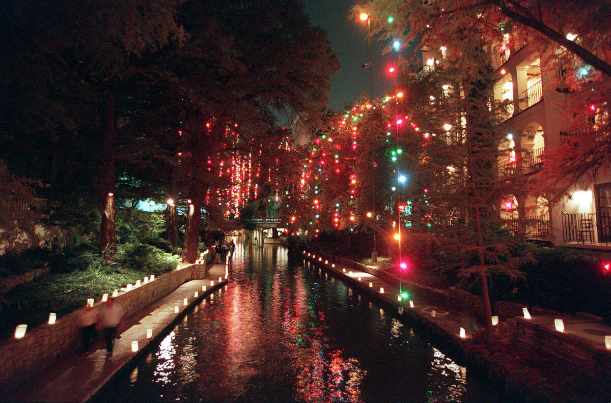 Pedestrians make their way through the Christmas lights along the Riverwalk on Sunday, December 6, 1998. 