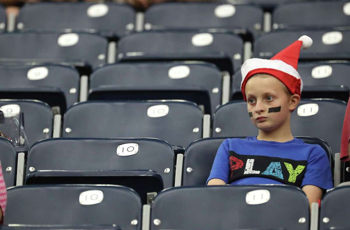 Surrounded by empty seats at NRG Stadium, a young fan takes in Sunday’s 31-0 Texans loss to the Colts.