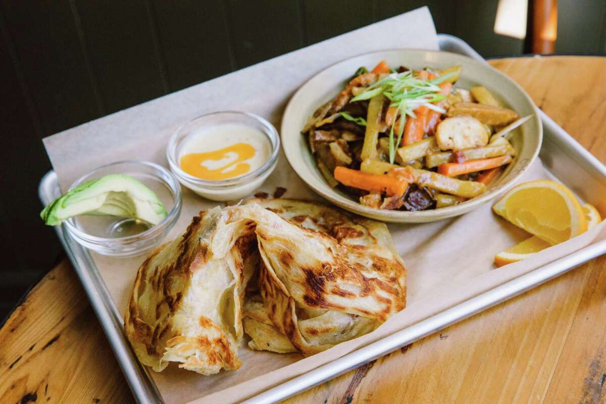 The Roti Comfort at Aman Cafe comes with crispy roti and soy tofu tossed with mixed veggies and Ethiopian spices.