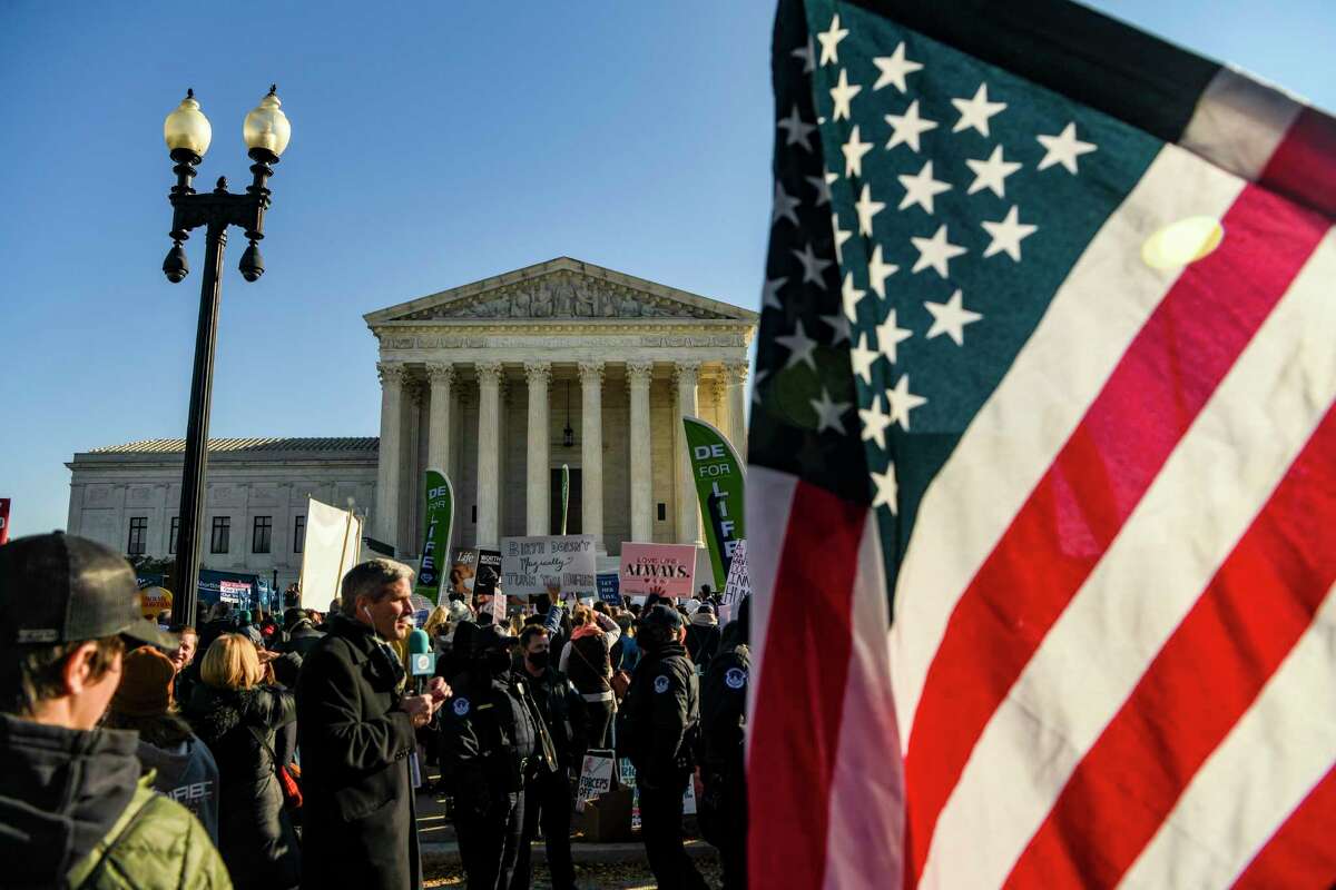 Demonstrators gathered outside the U.S. Supreme Court as justices heard arguments over a Mississippi law banning most abortions after 15 weeks of pregnancy.